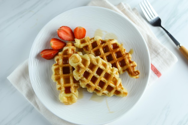 Croissant Waffle or croffle in white plate with strawberry