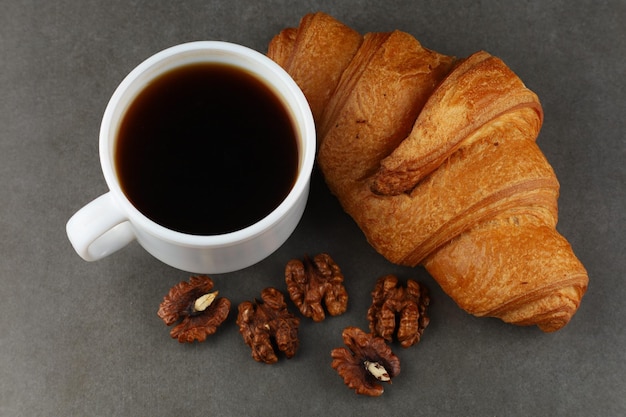 Croissant with coffee and nuts Hearty and healthy breakfast