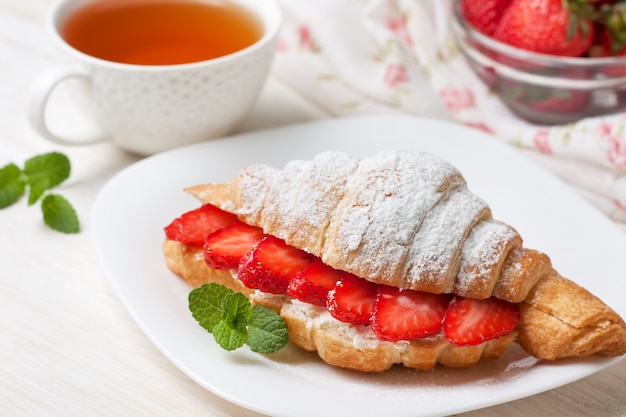 Croissant with fresh strawberries, ricotta