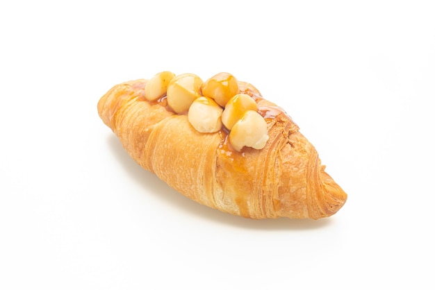 croissant with macadamia and caramel isolated on white background