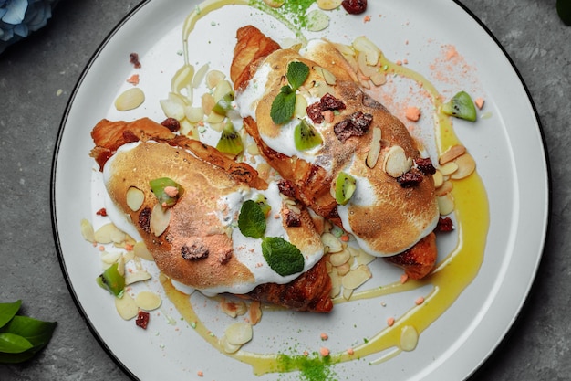 Croissant with sweet cream and almonds on a plate Delicious and healthy breakfast