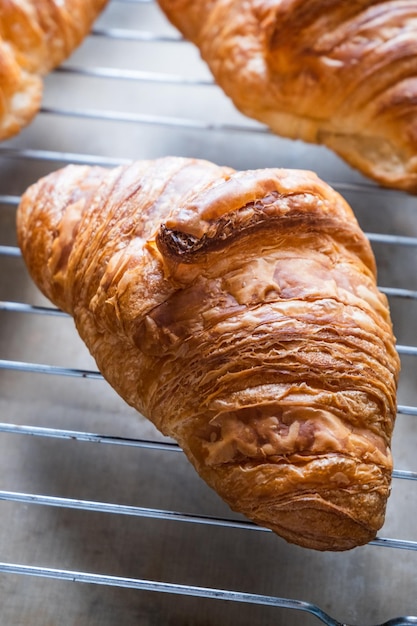 Croissants on baking rack