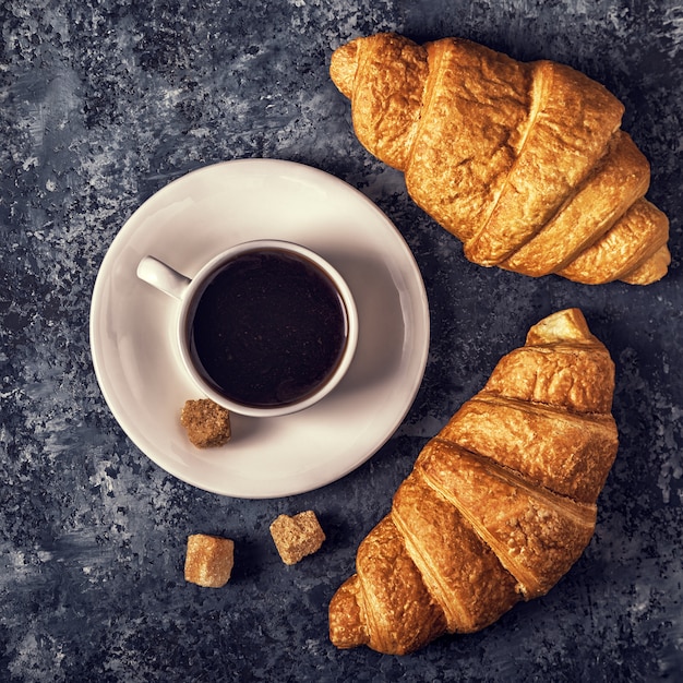 Croissants and coffee on a dark