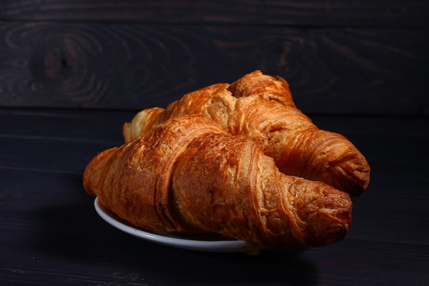 Croissants on a plate on a dark