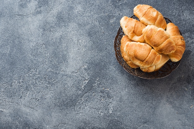 Croissants with chocolate filling on a plate gray background. 