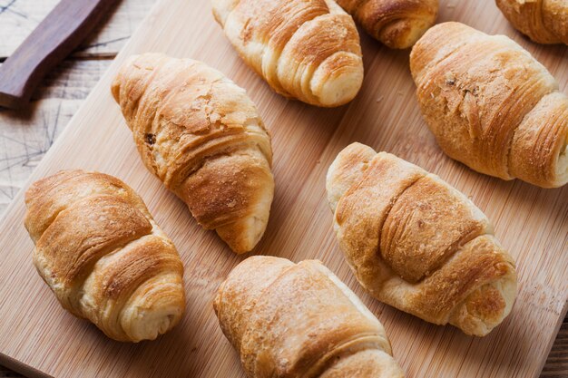 Croissants with chocolate filling on wooden background. Copy space.