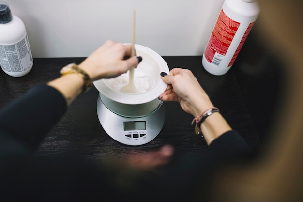 Photo crop hairdresser preparing hair colorant