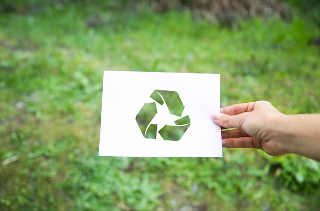 Crop hand with recycle symbol