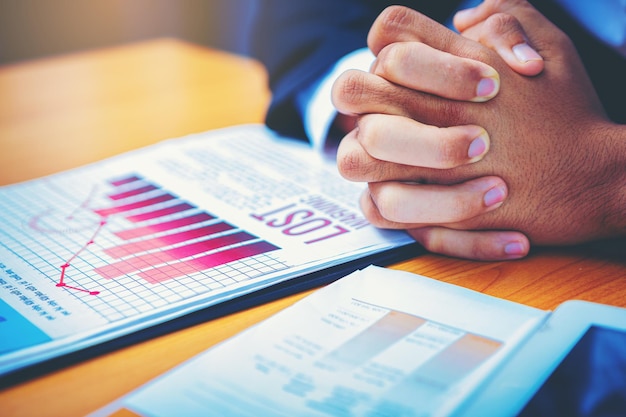 Crop image of businessman's hands holding from business disappointed and seriously business report