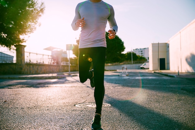 Crop man runningg on street