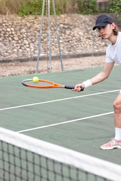 Croped view of young sportsman playing tennis hitting the tennis ball with the racket Movement image