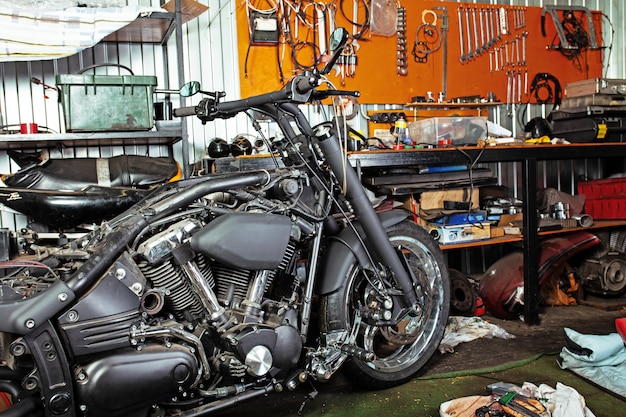 Cropped close up shot of beautiful and custom made motorcycle in the workshop