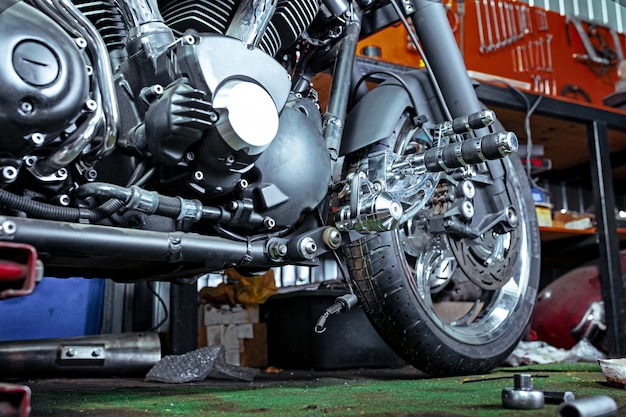 Cropped close up shot of beautiful and custom made motorcycle in the workshop