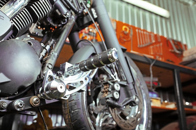 Cropped close up shot of beautiful and custom made motorcycle in the workshop