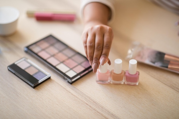 Cropped of female blogge showing various beauty products