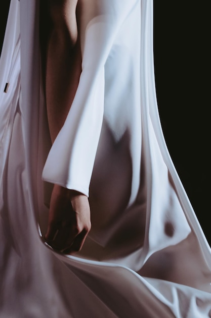 Cropped figure of fashion model woman wearing long white dress Casual clothes concept