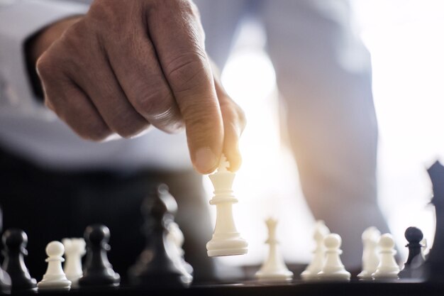 Cropped hand playing chess