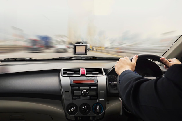 Cropped hands of man driving car