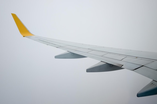 Cropped image of airplane flying against clear sky