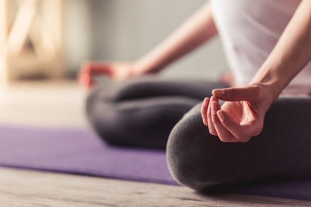 Cropped image of beautiful pregnant woman meditating.