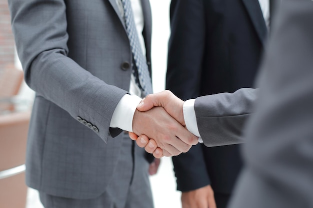 Cropped image of business people shaking hands in creative office