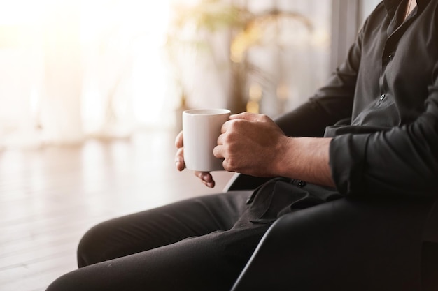 Cropped image of a businessman with a cup of coffee