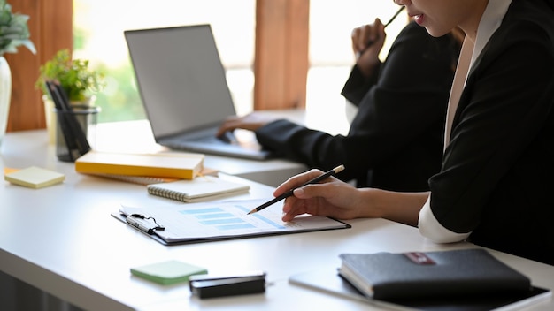 Cropped image of a businesspeople or financial analysts working as a team in the office.