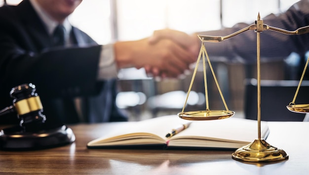 Cropped image of customer shaking hands with male lawyer at desk