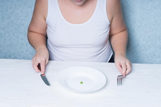 Cropped image of a girl eating peas weight loss diet Eating disorder