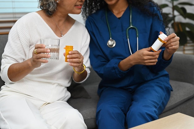 Cropped image of practitioner nurse explaining medicine dosage to senior patient Elderly healthcare concept