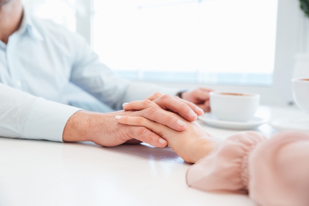 Cropped image of sensual lovely couple holding hand each other