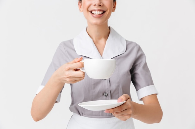 Cropped image of a smiling young housemaid