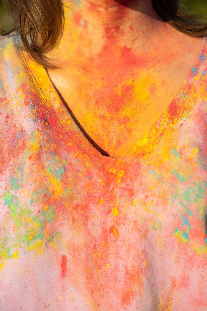 Cropped image of woman in tshirt covered colourful holi powder paint