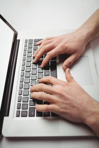 Cropped man working on laptop