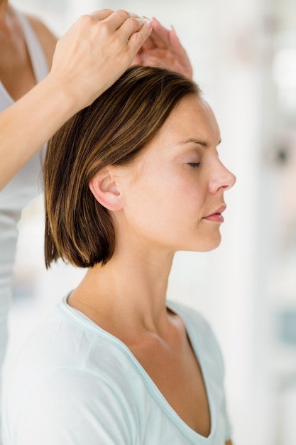 Cropped masseur giving massage to woman