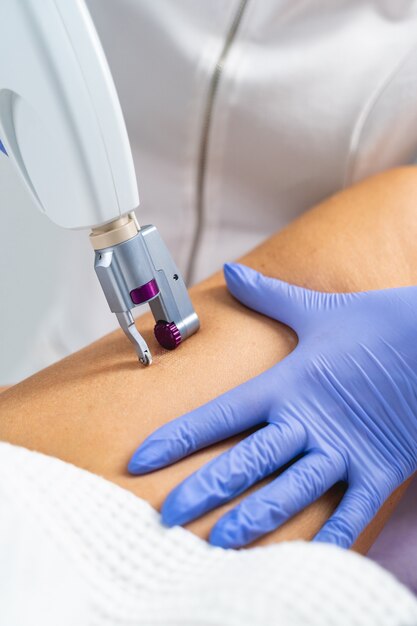 Cropped photo of a Caucasian woman receiving a figure correction treatment in a beauty salon