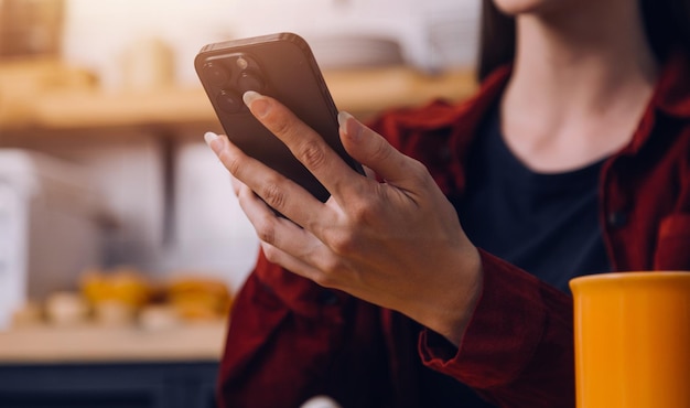 Cropped photo of Freelancer business Asian woman holding coffee cup and at doing planning analyzing the financial report business plan investment finance analysis the workplace