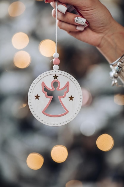 Cropped photo of lady holding beautiful decoration for Christmas tree. New Year eve concept