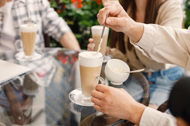 Cropped photo of three lattes on a tabler in a cafe outdoors