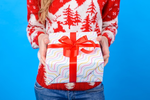 Cropped photo of woman's hands holding big present