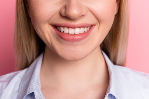 Cropped photo of young cheerful girl visit dentist toothy smile oral care clinic isolated over pink color background