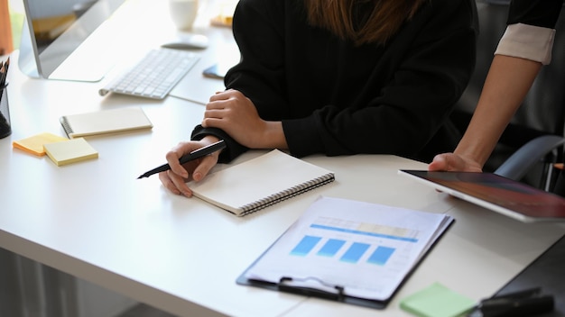 Cropped shot of a business team discussing having a small meeting in the office.