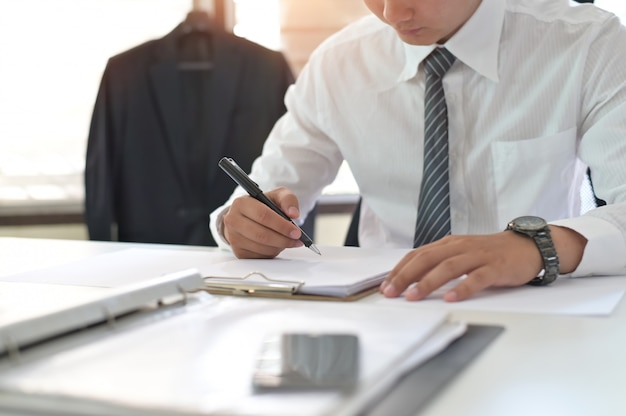 Cropped shot of businessman signing contract making a deal on office workplace.