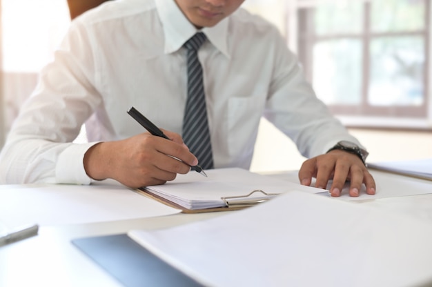 Cropped shot of businessman signing contract making a deal on office workplace.