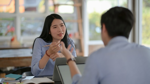 Cropped shot of businesspeople consulting on their work with laptop