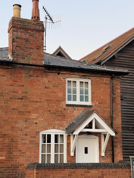 Cropped shot of a cozy small brick house with white windows