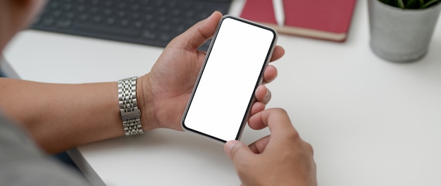 Cropped shot of male entrepreneur using smartphone