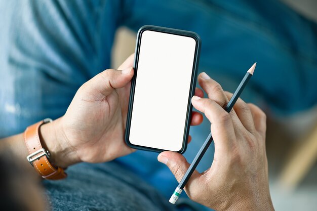 Cropped shot of man sitting and using mobile phone