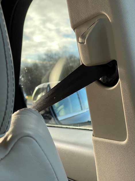 Cropped shot of safety seatbelt in a luxury car with beige interior