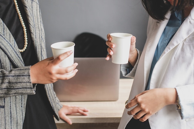 Cropped shot of two business woman have a coffee time at the office